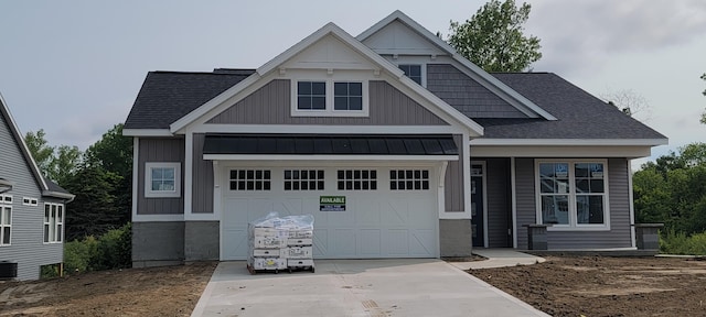 5478 Albright Ave SW Unit 50, Wyoming, MI 49418 - view of front facade featuring a standing seam roof, concrete driveway, a shingled roof, and a garage