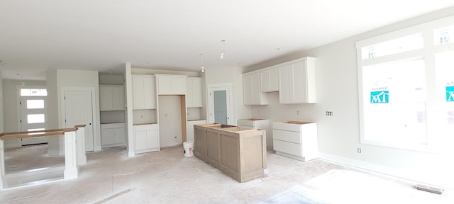 5478 Albright Ave SW Unit 50, Wyoming, MI 49418 - kitchen with a center island, plenty of natural light, and white cabinets