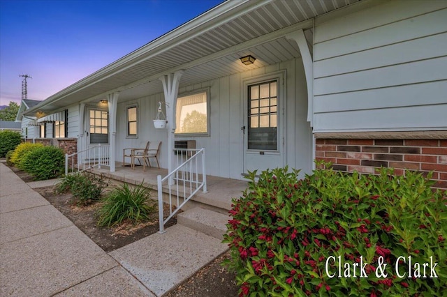 787 Andover St SE Unit 7, Grand Rapids, MI 49548 - exterior entry at dusk featuring covered porch and board and batten siding