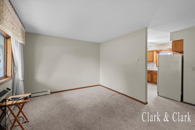 787 Andover St SE Unit 7, Grand Rapids, MI 49548 - empty room with light colored carpet, plenty of natural light, a baseboard radiator, and baseboards