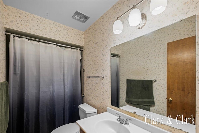 787 Andover St SE Unit 7, Grand Rapids, MI 49548 - bathroom with wallpapered walls, toilet, and vanity