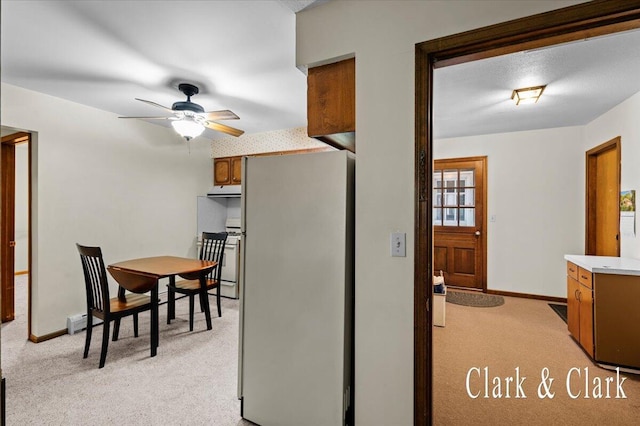 787 Andover St SE Unit 7, Grand Rapids, MI 49548 - dining area featuring light carpet, ceiling fan, a baseboard radiator, and baseboards