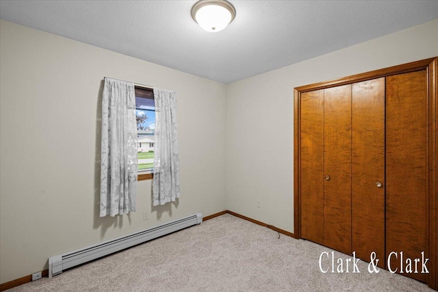 787 Andover St SE Unit 7, Grand Rapids, MI 49548 - unfurnished bedroom with a baseboard radiator, baseboards, carpet floors, and a closet