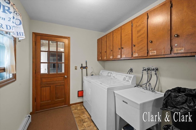 787 Andover St SE Unit 7, Grand Rapids, MI 49548 - laundry area featuring washing machine and dryer, cabinet space, a baseboard heating unit, and baseboards