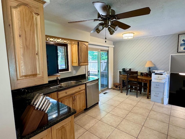 3671 Lido, Highland, MI 48356 - kitchen featuring stainless steel dishwasher, a textured ceiling, a ceiling fan, light tile patterned floors, and dark stone countertops
