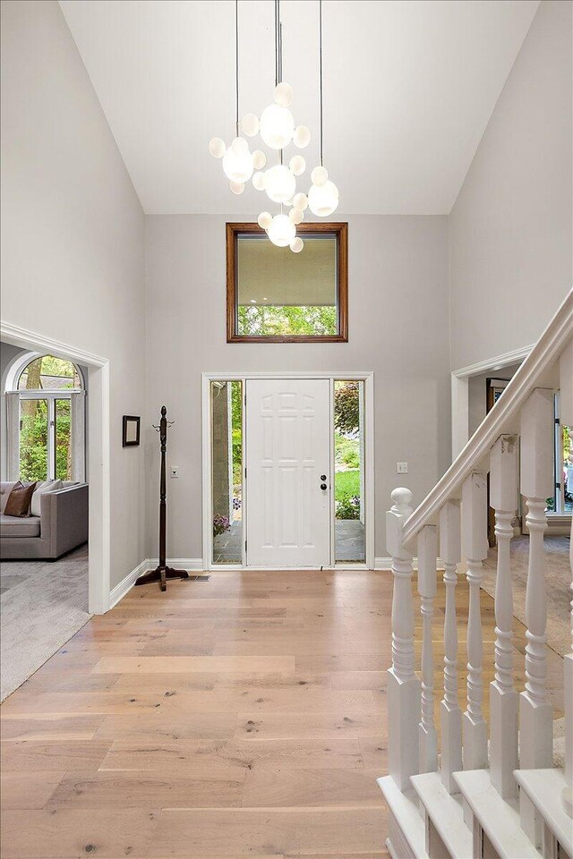 3427 E Dobson Pl, Ann Arbor, MI 48105 - entryway featuring a towering ceiling, a chandelier, wood finished floors, and baseboards