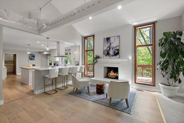 3427 E Dobson Pl, Ann Arbor, MI 48105 - living room with a fireplace, light wood-type flooring, baseboards, recessed lighting, and vaulted ceiling