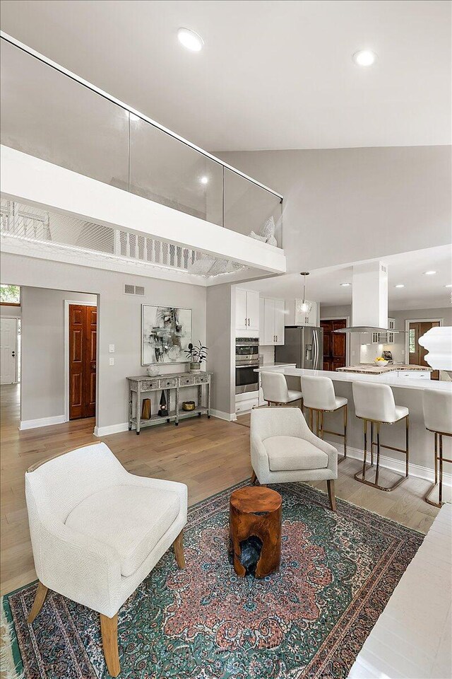 3427 E Dobson Pl, Ann Arbor, MI 48105 - living room with a towering ceiling, light wood-type flooring, baseboards, and recessed lighting