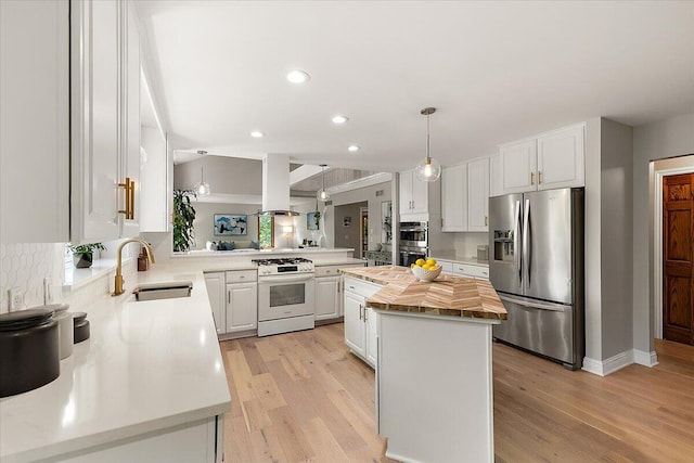 3427 E Dobson Pl, Ann Arbor, MI 48105 - kitchen with appliances with stainless steel finishes, butcher block countertops, a sink, a kitchen island, and recessed lighting