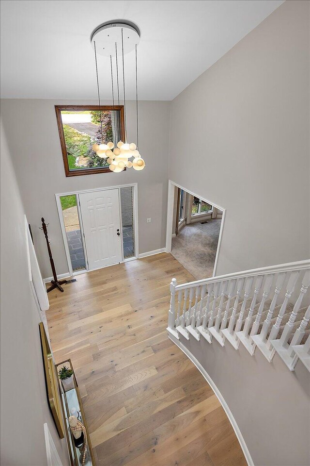 3427 E Dobson Pl, Ann Arbor, MI 48105 - entryway featuring a chandelier, wood finished floors, baseboards, and a high ceiling
