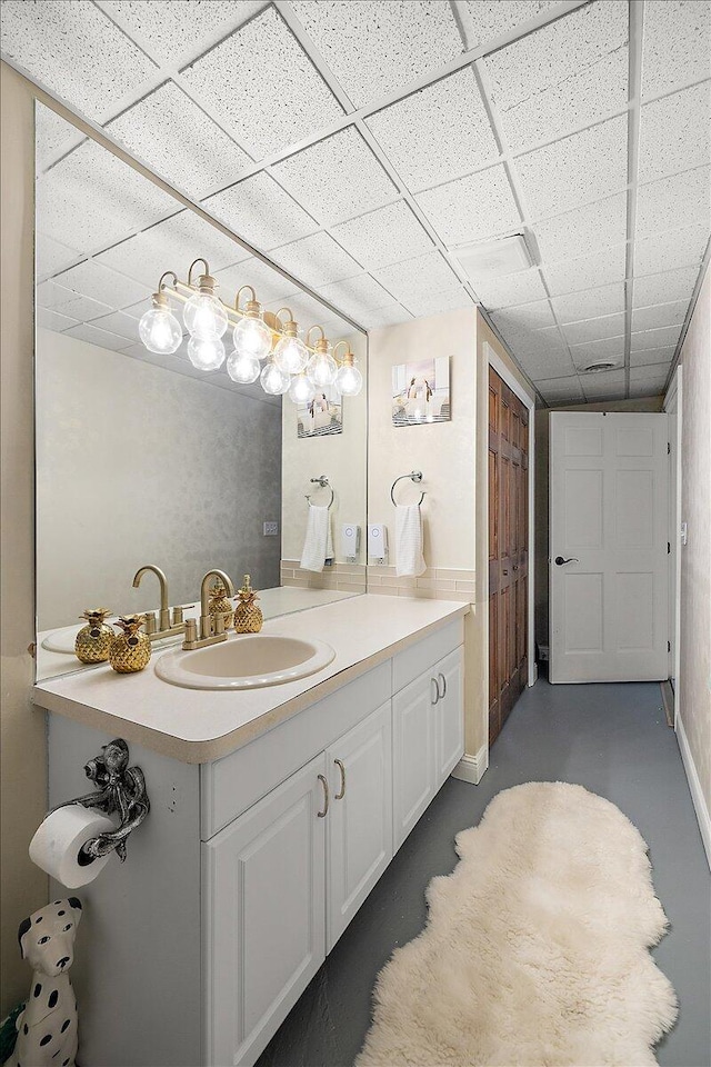 3427 E Dobson Pl, Ann Arbor, MI 48105 - bathroom featuring a paneled ceiling, vanity, and concrete floors