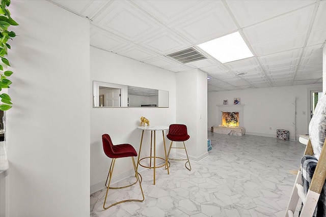 3427 E Dobson Pl, Ann Arbor, MI 48105 - bar area featuring light marble finish flooring, baseboards, and a lit fireplace