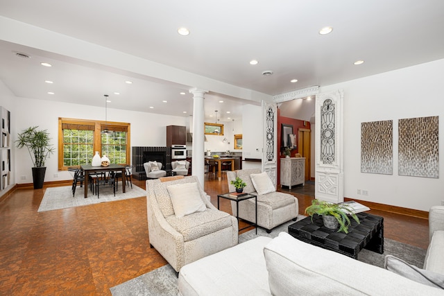 818 S 7th St, Ann Arbor, MI 48103 - living room featuring ornate columns, recessed lighting, baseboards, and a fireplace