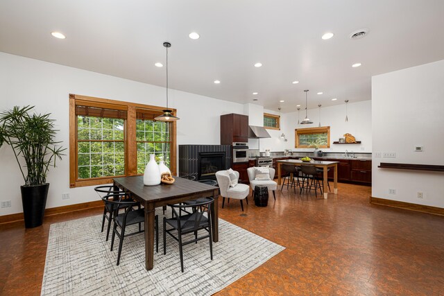 818 S 7th St, Ann Arbor, MI 48103 - dining room with a fireplace, recessed lighting, and baseboards