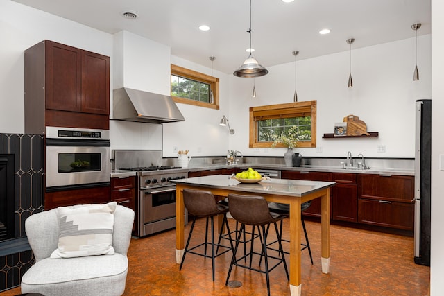 818 S 7th St, Ann Arbor, MI 48103 - kitchen featuring appliances with stainless steel finishes, ventilation hood, recessed lighting, a sink, and hanging light fixtures