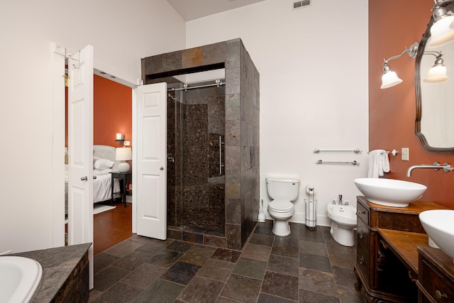 818 S 7th St, Ann Arbor, MI 48103 - ensuite bathroom featuring a bidet, a shower stall, double vanity, and stone finish flooring