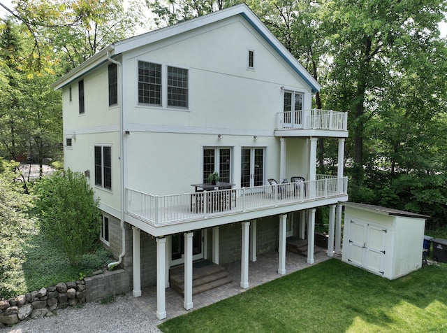 818 S 7th St, Ann Arbor, MI 48103 - rear view of property featuring a yard, a balcony, stucco siding, and a patio area