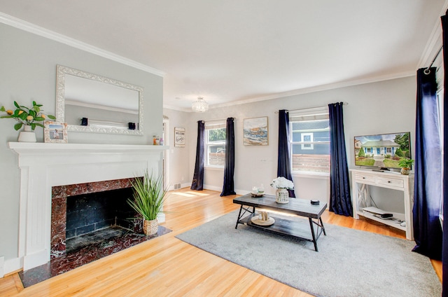533 Beech St, East Lansing, MI 48823 - living area featuring ornamental molding, wood finished floors, a tile fireplace, and baseboards