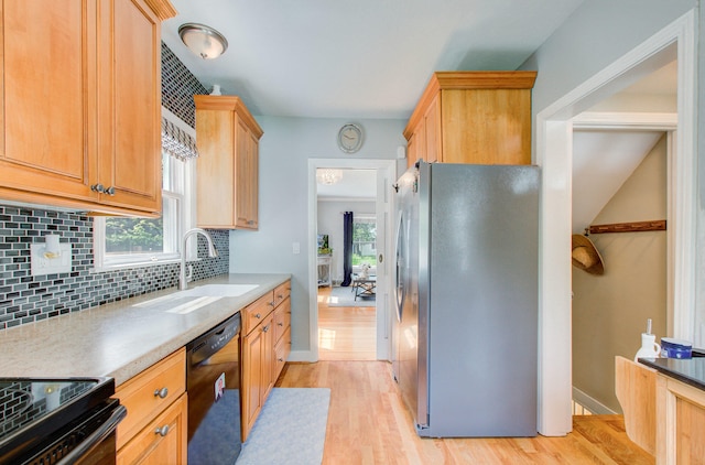 533 Beech St, East Lansing, MI 48823 - kitchen featuring stainless steel refrigerator with ice dispenser, dishwasher, a sink, light wood finished floors, and decorative backsplash