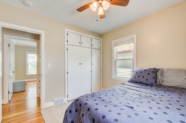 533 Beech St, East Lansing, MI 48823 - bedroom featuring light wood finished floors, baseboards, a closet, and ceiling fan