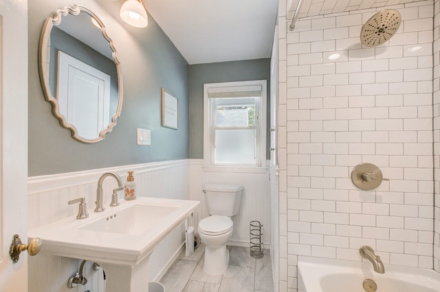 533 Beech St, East Lansing, MI 48823 - full bath with a sink, toilet, a wainscoted wall, and bathing tub / shower combination