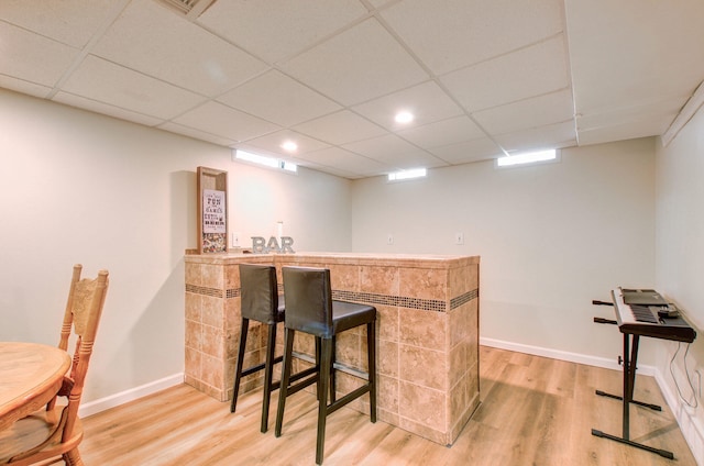 533 Beech St, East Lansing, MI 48823 - indoor bar featuring light wood finished floors, a paneled ceiling, and baseboards