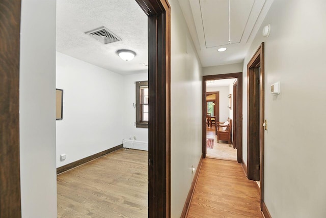 1630 S 3rd St, Niles, MI 49120 - corridor featuring attic access, light wood-style flooring, and baseboards