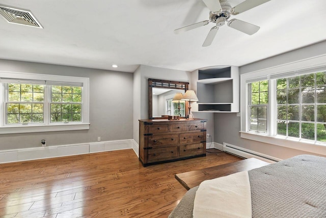 1630 S 3rd St, Niles, MI 49120 - bedroom featuring baseboard heating, hardwood / wood-style floors, baseboards, and a ceiling fan