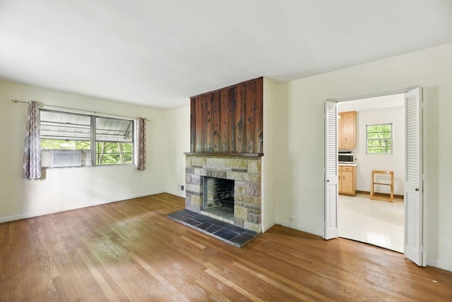 1630 S 3rd St, Niles, MI 49120 - unfurnished living room featuring light wood-style floors, a fireplace, and baseboards