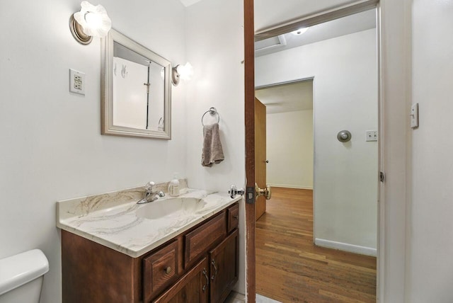1630 S 3rd St, Niles, MI 49120 - half bath featuring vanity, wood finished floors, toilet, and baseboards