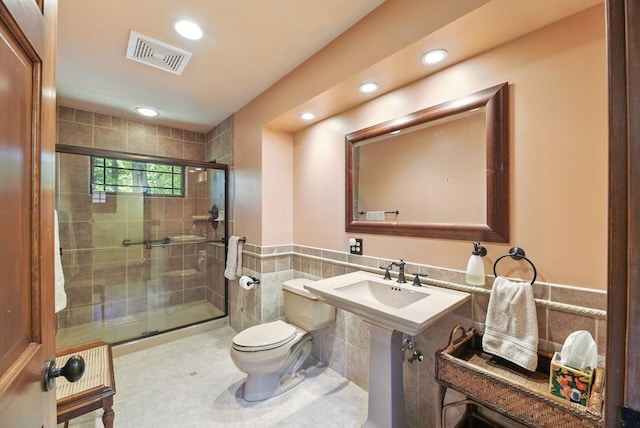 1630 S 3rd St, Niles, MI 49120 - bathroom with toilet, tile walls, a stall shower, recessed lighting, and wainscoting