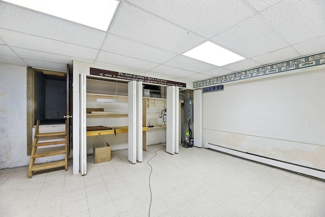 1630 S 3rd St, Niles, MI 49120 - finished below grade area featuring a paneled ceiling, baseboard heating, concrete block wall, tile patterned floors, and stairway