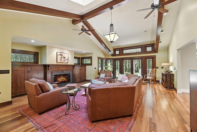 1630 S 3rd St, Niles, MI 49120 - living area with ceiling fan, high vaulted ceiling, a glass covered fireplace, light wood-type flooring, and beam ceiling