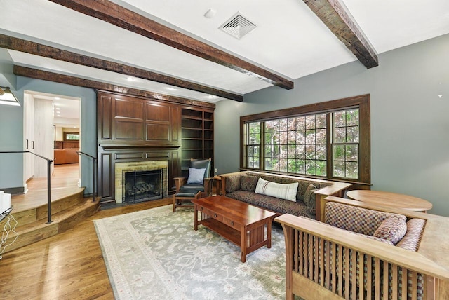 1630 S 3rd St, Niles, MI 49120 - living area with light wood-style floors, a fireplace with flush hearth, and beamed ceiling