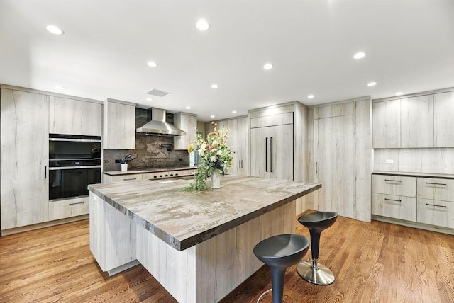1630 S 3rd St, Niles, MI 49120 - kitchen featuring wall chimney range hood, modern cabinets, a kitchen breakfast bar, a large island, and recessed lighting