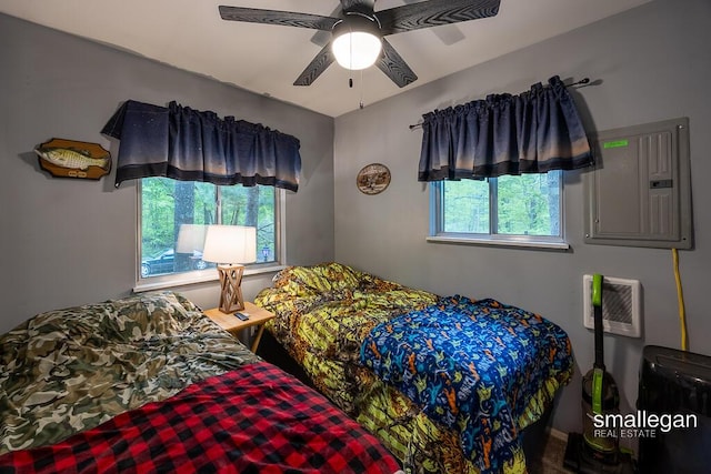 9134 39th Ave, Bitely, MI 49309 - bedroom with electric panel, a wall unit AC, and a ceiling fan