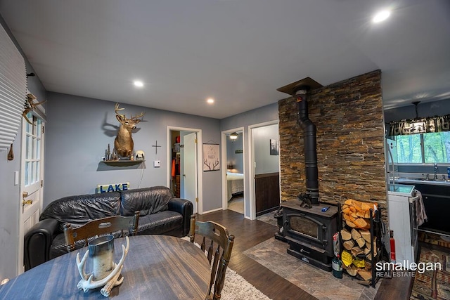 9134 39th Ave, Bitely, MI 49309 - dining space featuring a wood stove, wood finished floors, recessed lighting, and baseboards