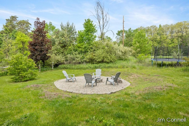 1480 W 72nd St, Newaygo, MI 49337 - view of green lawn featuring a trampoline and a fire pit
