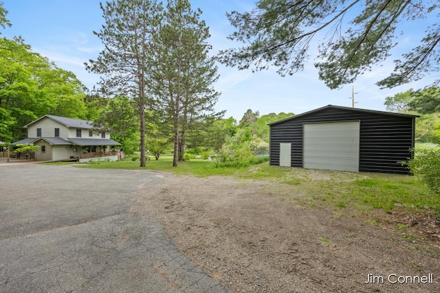 1480 W 72nd St, Newaygo, MI 49337 - view of yard with an outbuilding, driveway, and a garage