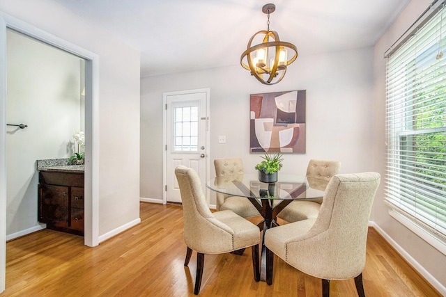 429 S 7th St # 1, Ann Arbor, MI 48103 - dining room with a chandelier, light wood-style flooring, and baseboards
