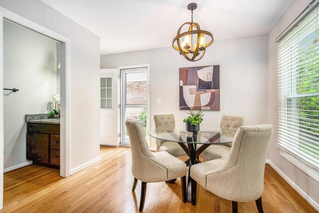429 S 7th St # 1, Ann Arbor, MI 48103 - dining area featuring a chandelier, light wood-type flooring, and baseboards