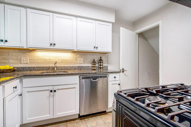 429 S 7th St # 1, Ann Arbor, MI 48103 - kitchen with stainless steel dishwasher, a sink, decorative backsplash, white cabinets, and dark stone countertops