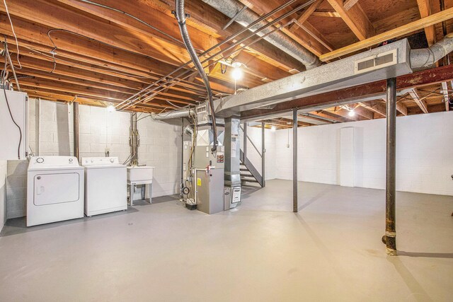 429 S 7th St # 1, Ann Arbor, MI 48103 - unfinished basement with heating unit, independent washer and dryer, stairway, a sink, and concrete block wall