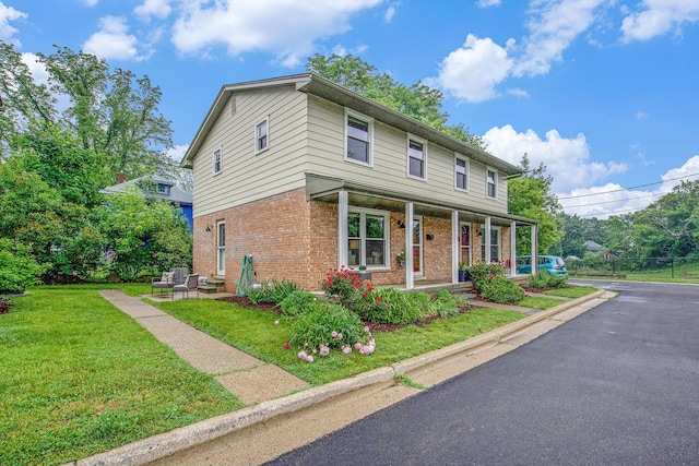 429 S 7th St # 1, Ann Arbor, MI 48103 - traditional-style home with brick siding, a porch, and a front yard