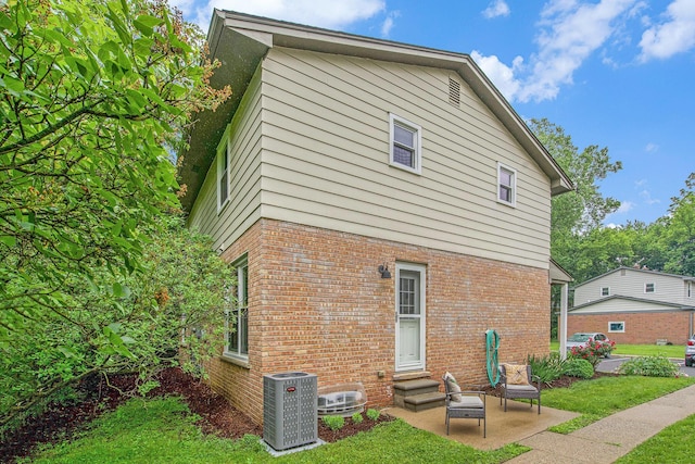 429 S 7th St # 1, Ann Arbor, MI 48103 - back of house featuring central AC, a yard, brick siding, a patio, and entry steps