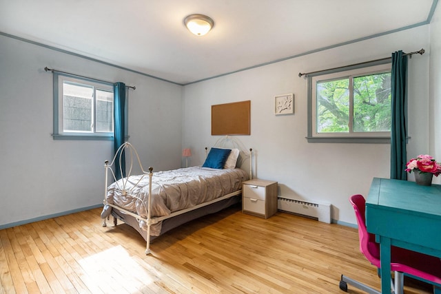2305 S Circle Dr, Ann Arbor, MI 48103 - bedroom with baseboard heating, multiple windows, light wood finished floors, and baseboards