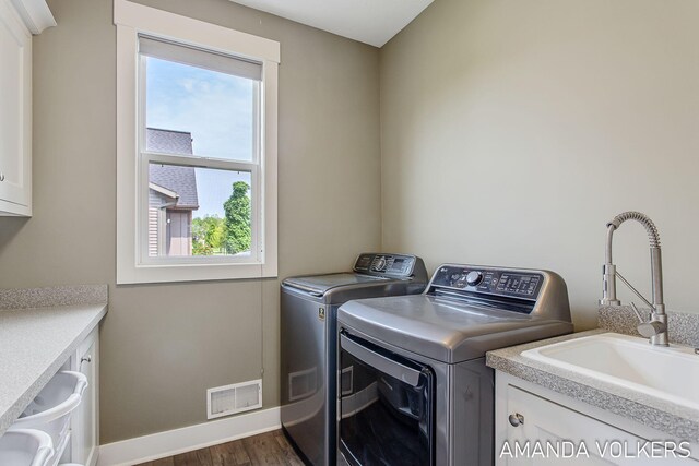 1551 Providence Cove Ct, Byron Center, MI 49315 - laundry area featuring cabinet space, washer and clothes dryer, dark wood finished floors, and baseboards