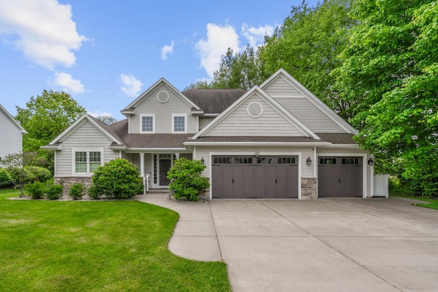 10693 Bear Lake Trl, Portage, MI 49024 - view of front of house featuring stone siding, an attached garage, driveway, and a front lawn