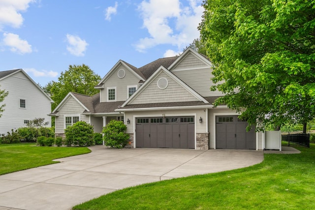 10693 Bear Lake Trl, Portage, MI 49024 - view of front of property with concrete driveway, an attached garage, stone siding, and a shingled roof