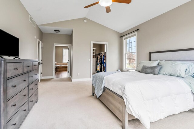 10693 Bear Lake Trl, Portage, MI 49024 - bedroom with light carpet, a spacious closet, vaulted ceiling, baseboards, and a closet